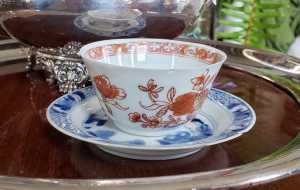 blood and milk tea cup and blue white saucer