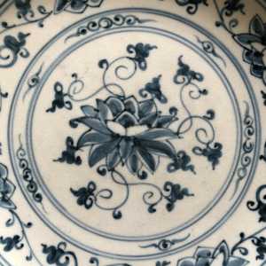 Antique likely Korean blue and white pottery plate lotus design close up note ice crackle glaze.