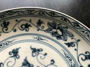 Antique likely Korean blue and white pottery plate lotus design edge detail.